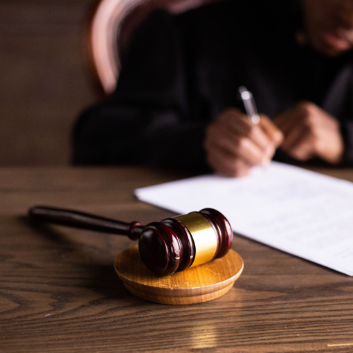 Judge signing legal paperwork.